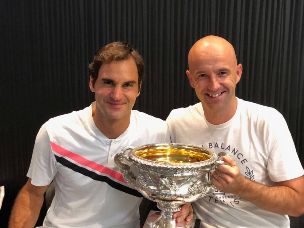 Ivan Ljubicic Coaching Roger Federer During A Tennis Match Background