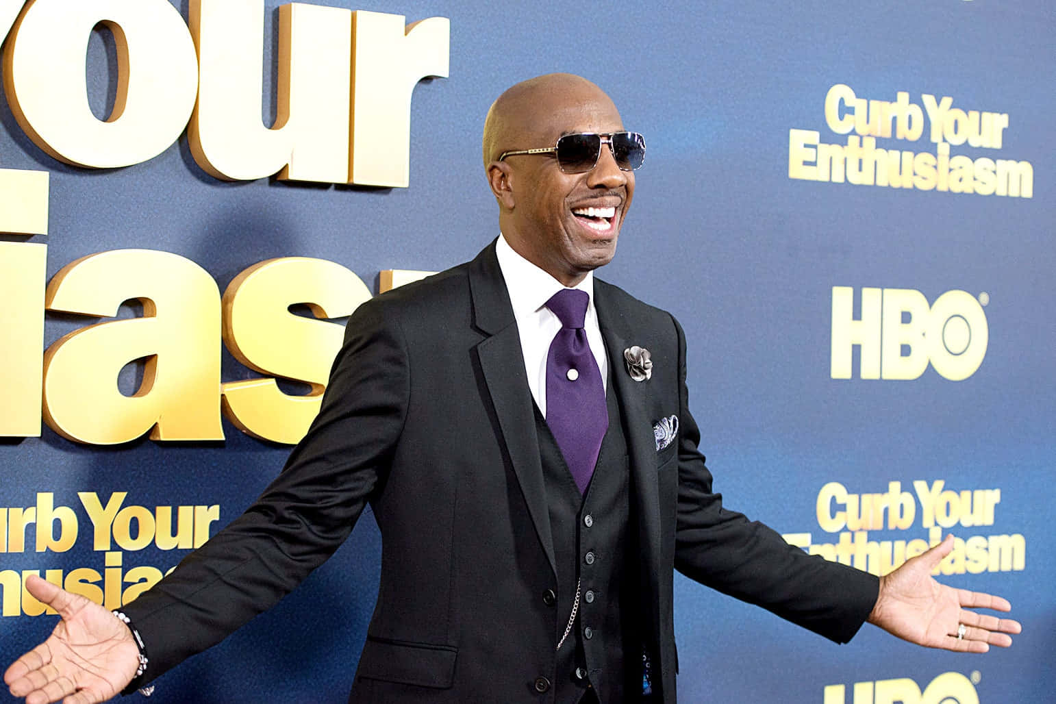 J.b. Smoove Looks Gleefully At A Camera Background