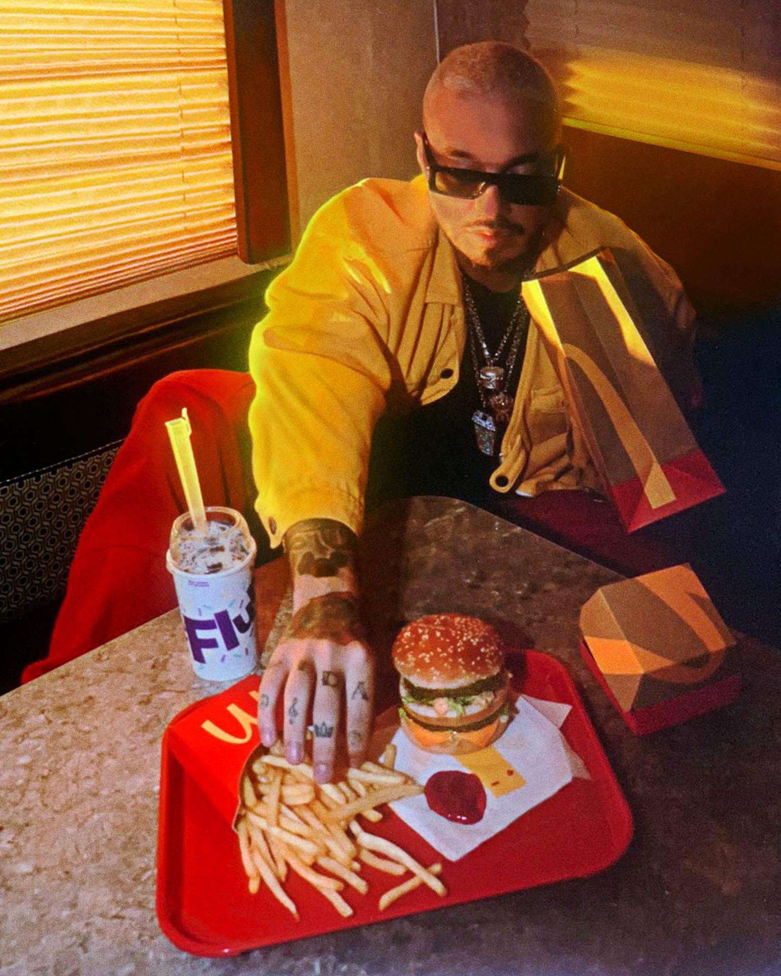 J Balvin Eating Burger And Fries Background