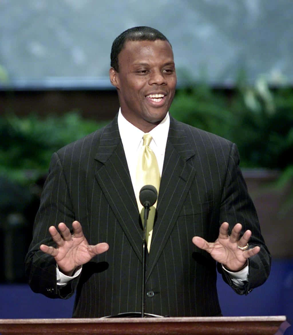 J.c. Watts In The Podium Background