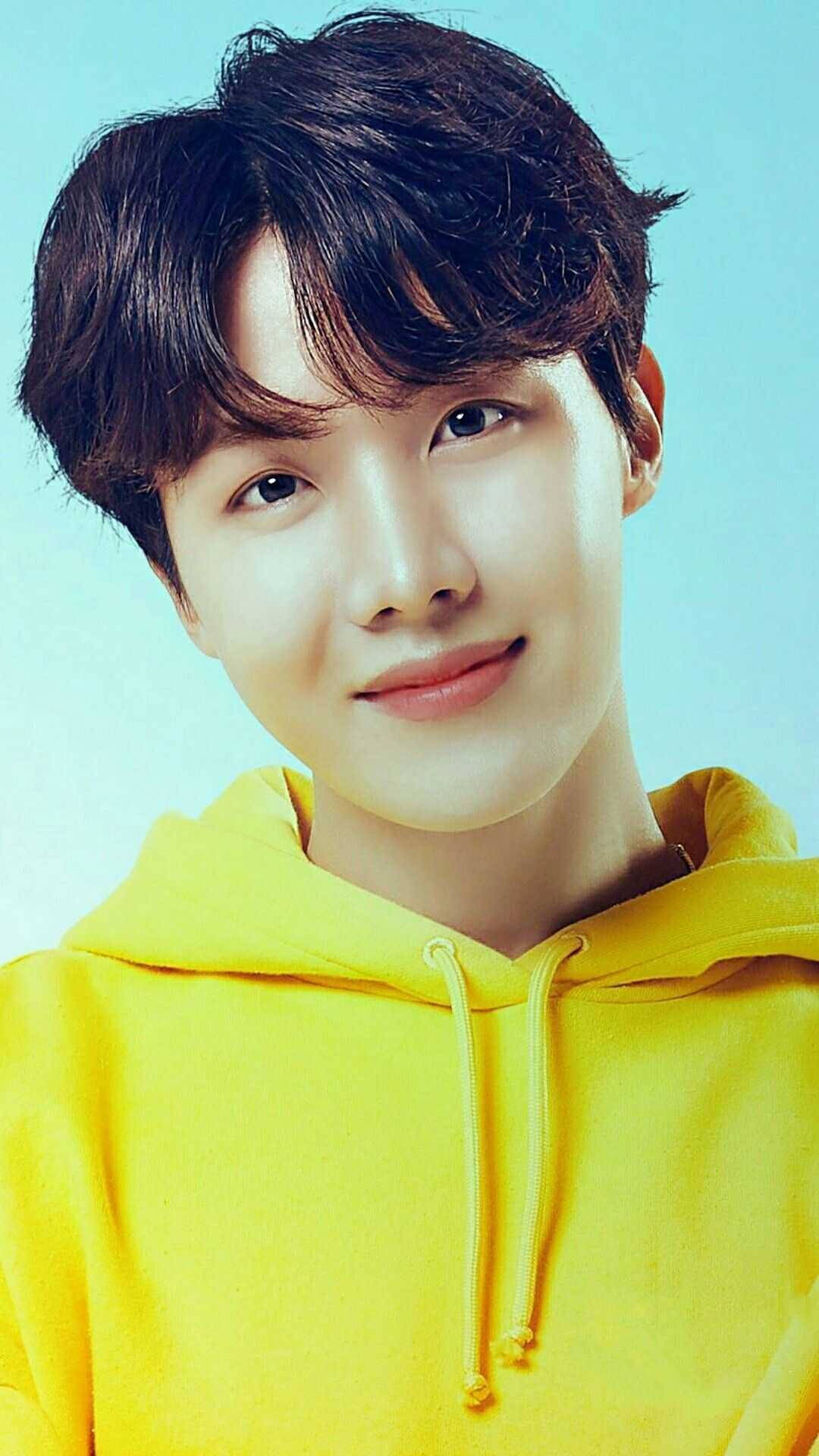 J-hope Donning A Yellow Hoodie Background