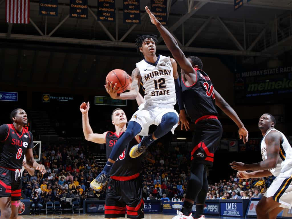 Ja Morrant Being Guarded By The Other Player Background