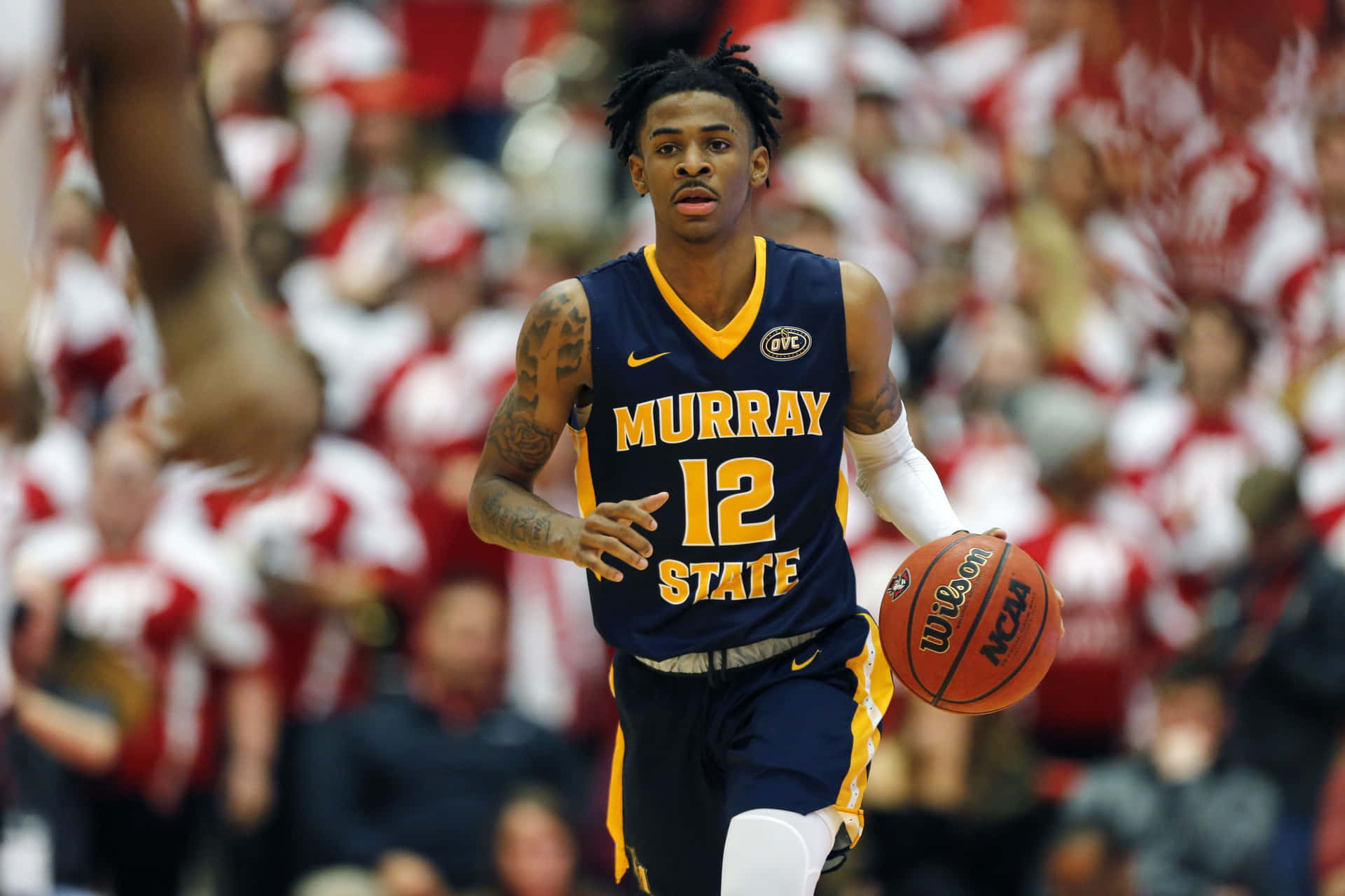 Ja Morrant Dribbling A Ball Background