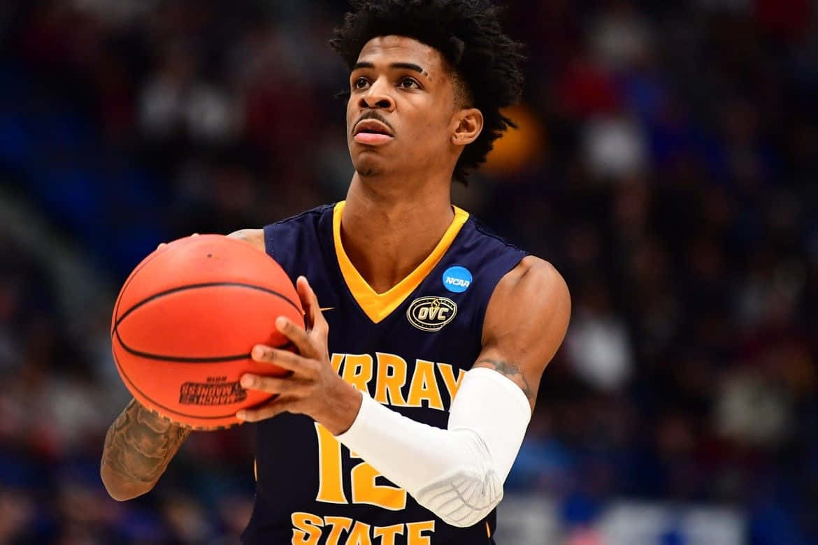 Ja Morrant Holding A Ball Background