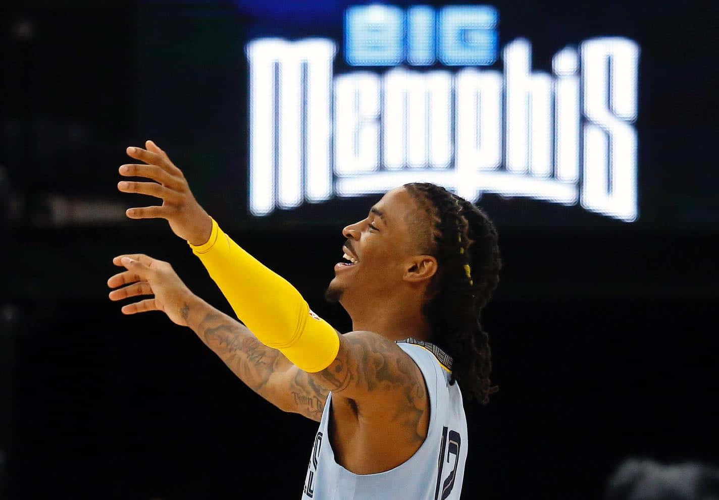 Ja Morrant Raising Both Hands Background