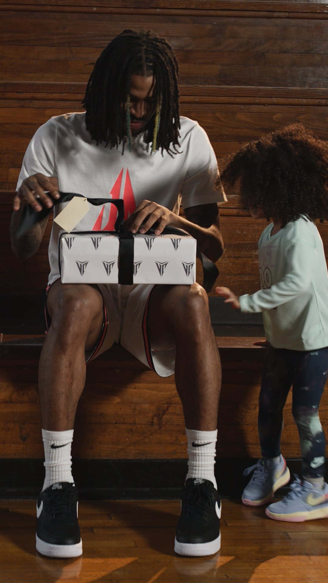 Ja Morrant Unboxing A Package With His Daughter Background