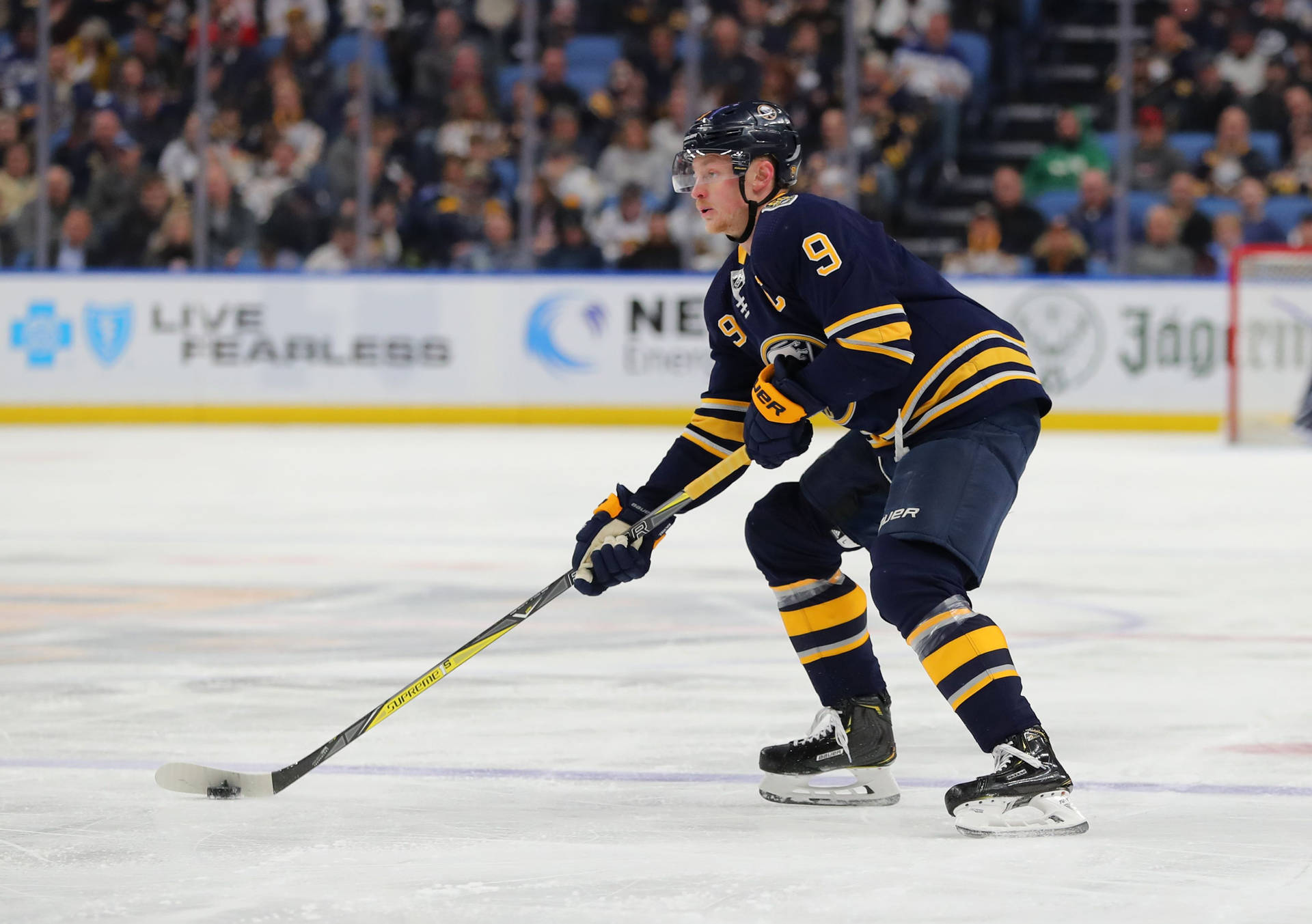 Jack Eichel, Star Player Of Buffalo Sabres, Skillfully Handling The Puck Background