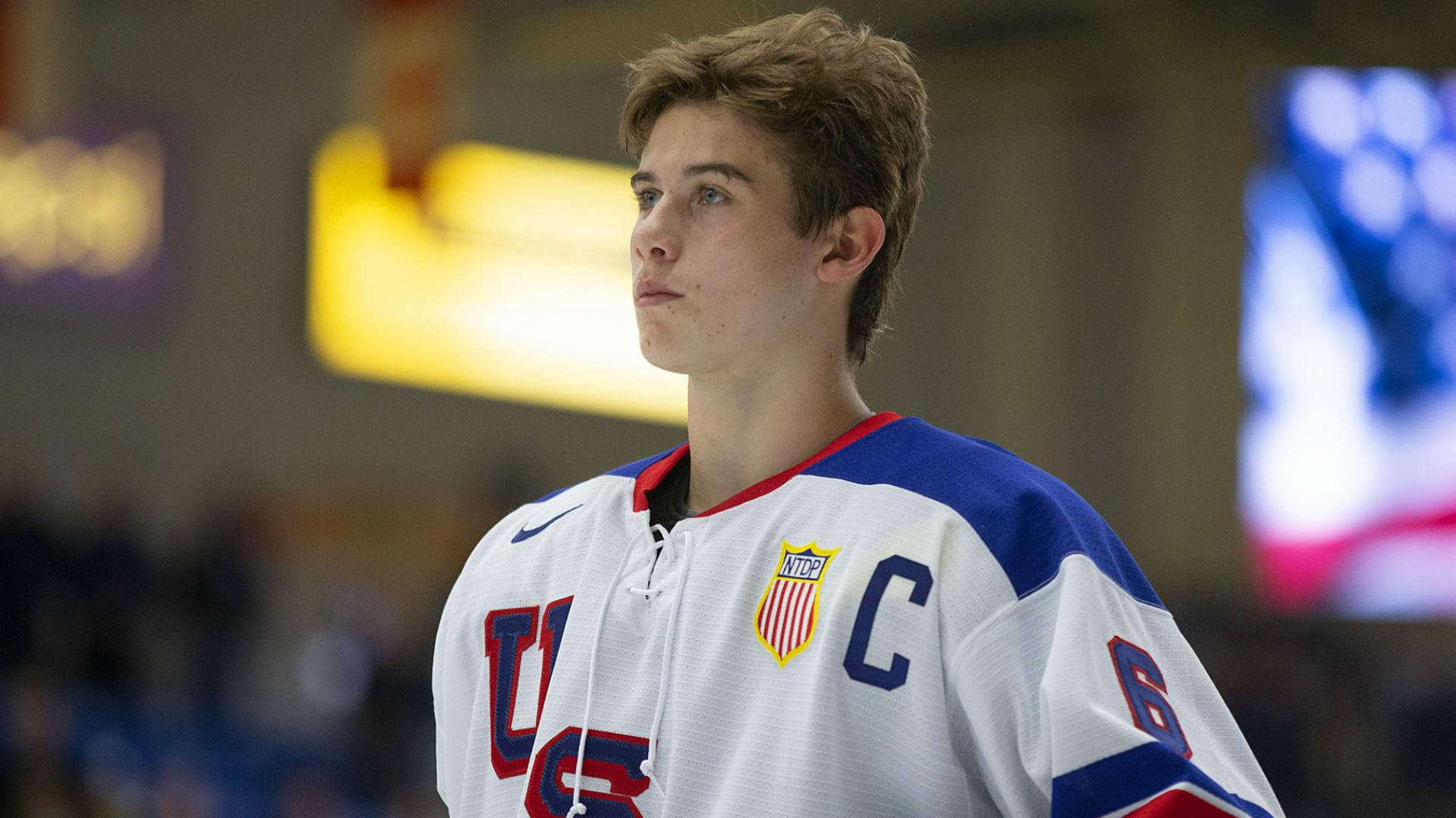 Jack Hughes In Action During A Hockey Match Background