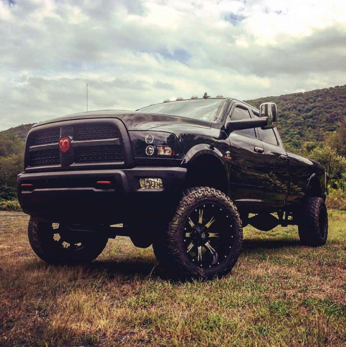 Jacked Up Trucks By The Mountains Background