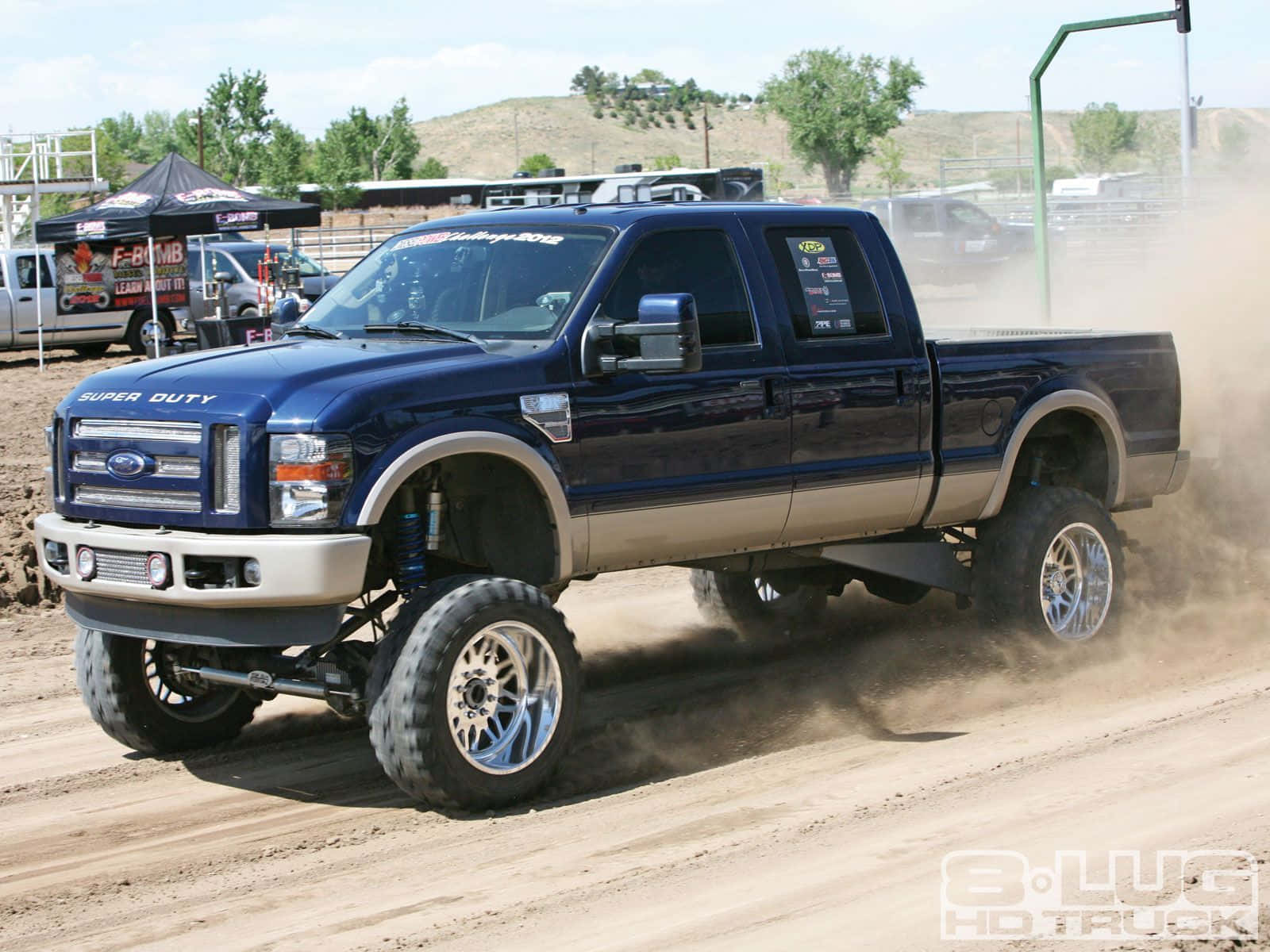 Jacked Up Trucks Creating A Dusty Trail Background