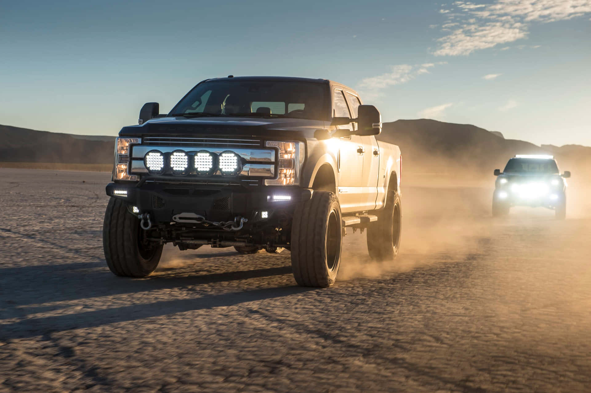 Jacked Up Trucks With Lit-up Headlamps Background