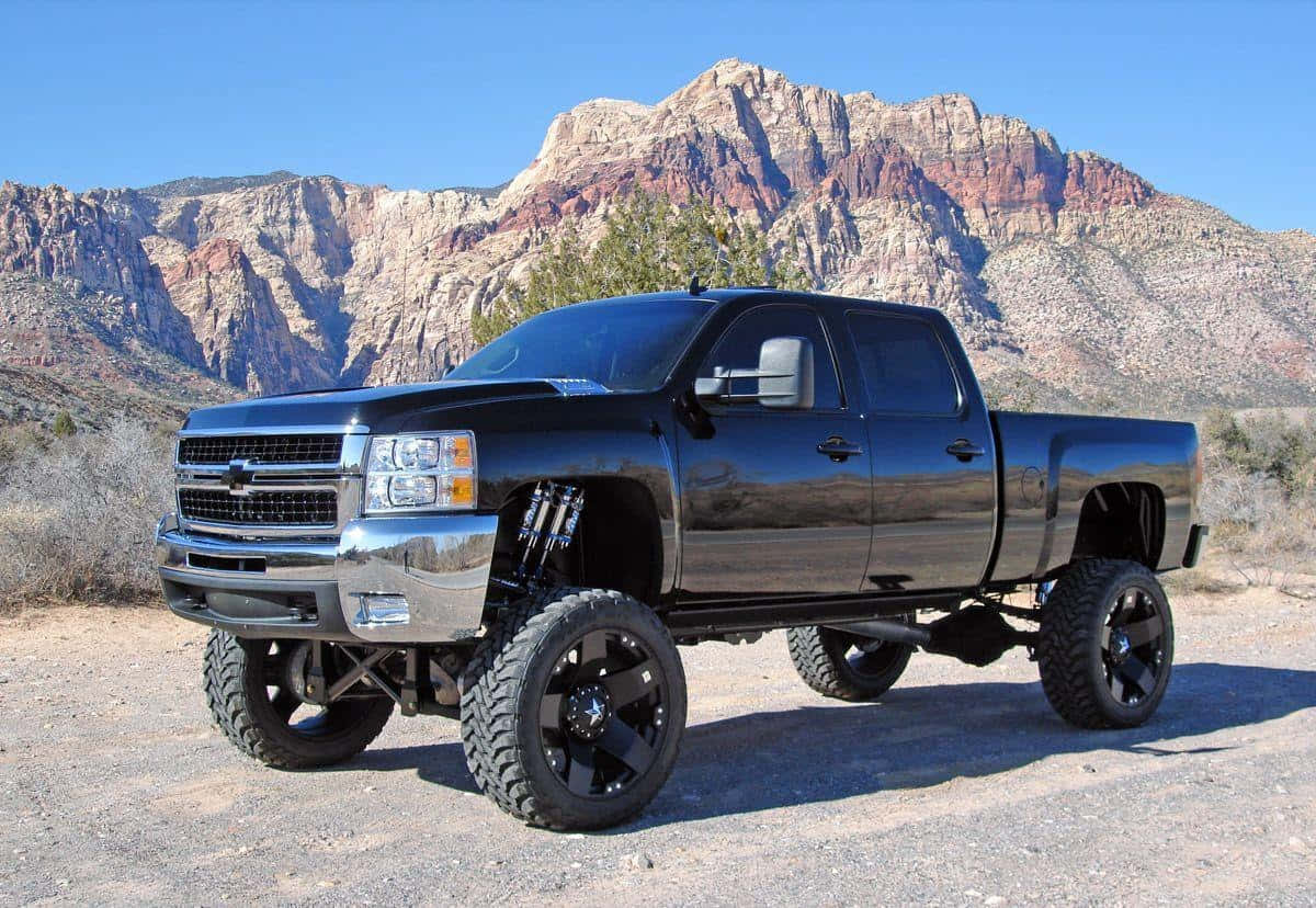 Jacked Up Trucks With Rocky Mountains Background