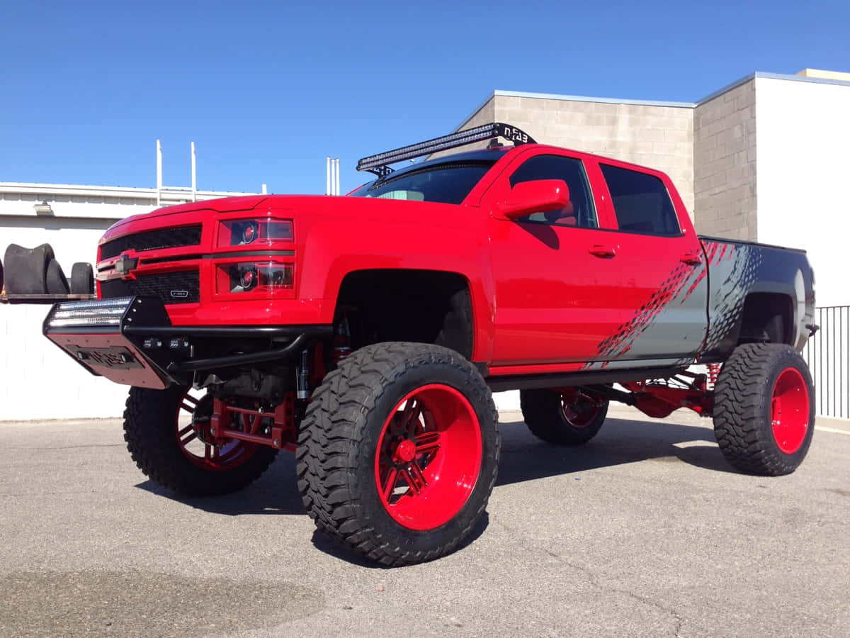 Jacked Up Trucks With Vibrant Red Paint Background