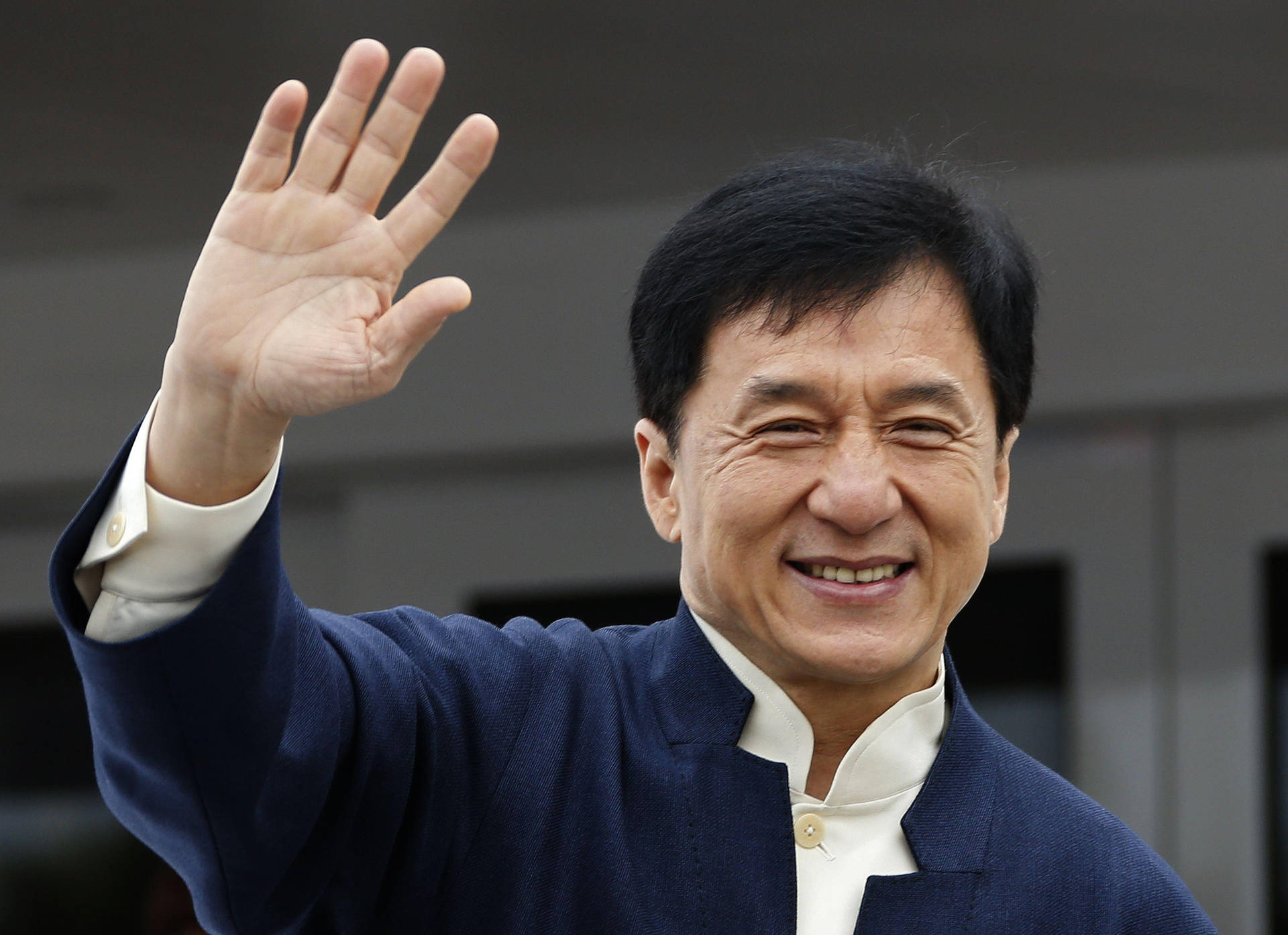 Jackie Chan Cheerfully Waving Background