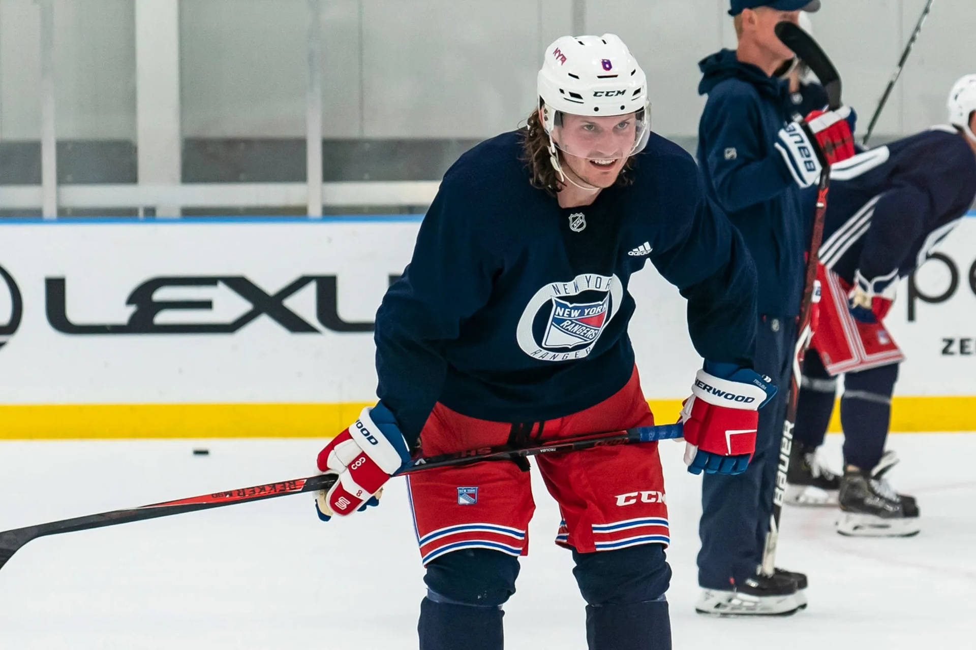 Jacob Trouba Smiling While Leaning Forward During Training Background