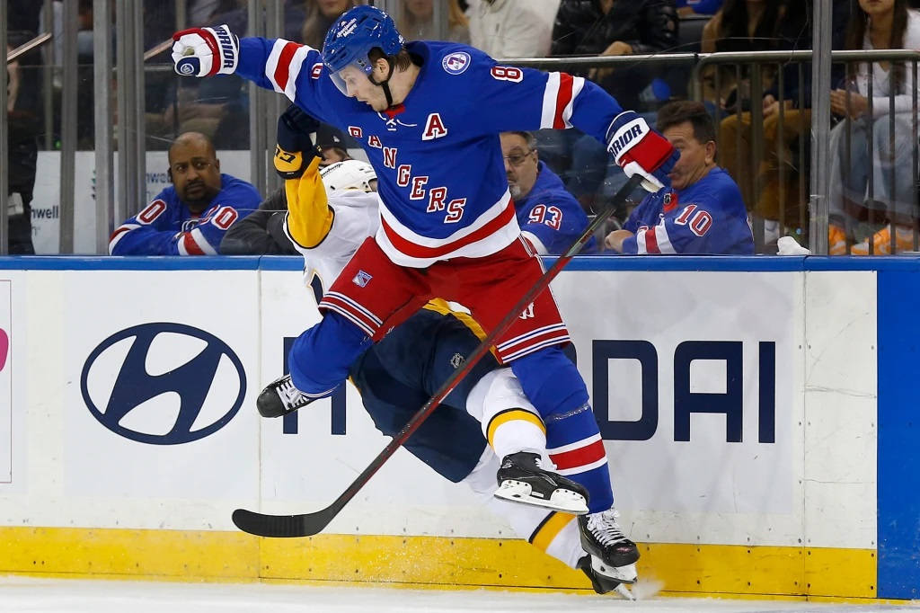 Jacob Trouba Stumble During Game Against Player From Boston Bruins Background