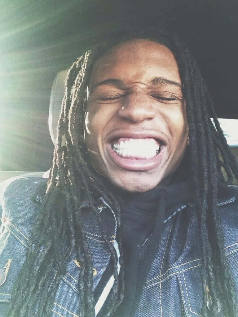 Jacquees Smiling Inside The Car Background
