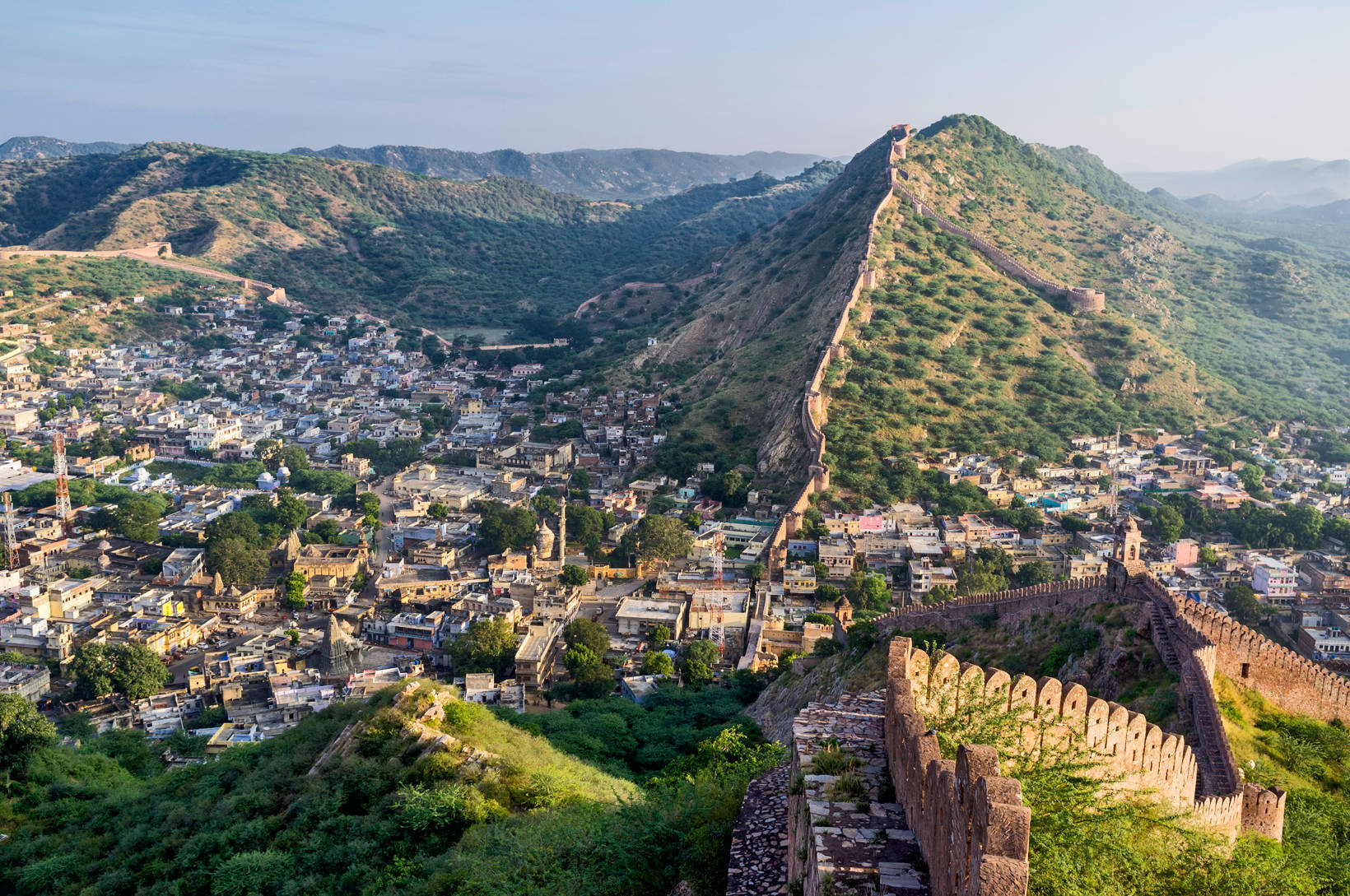 Jaipur City Buildings And Hills Background