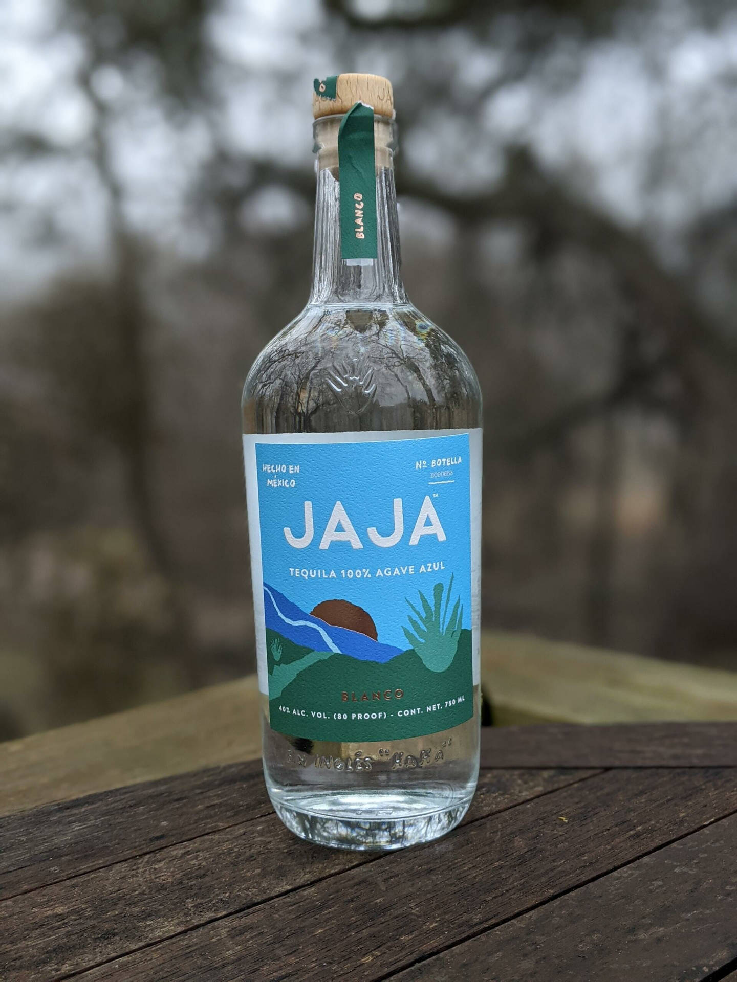 Jaja Tequila Bottle At Woods Background