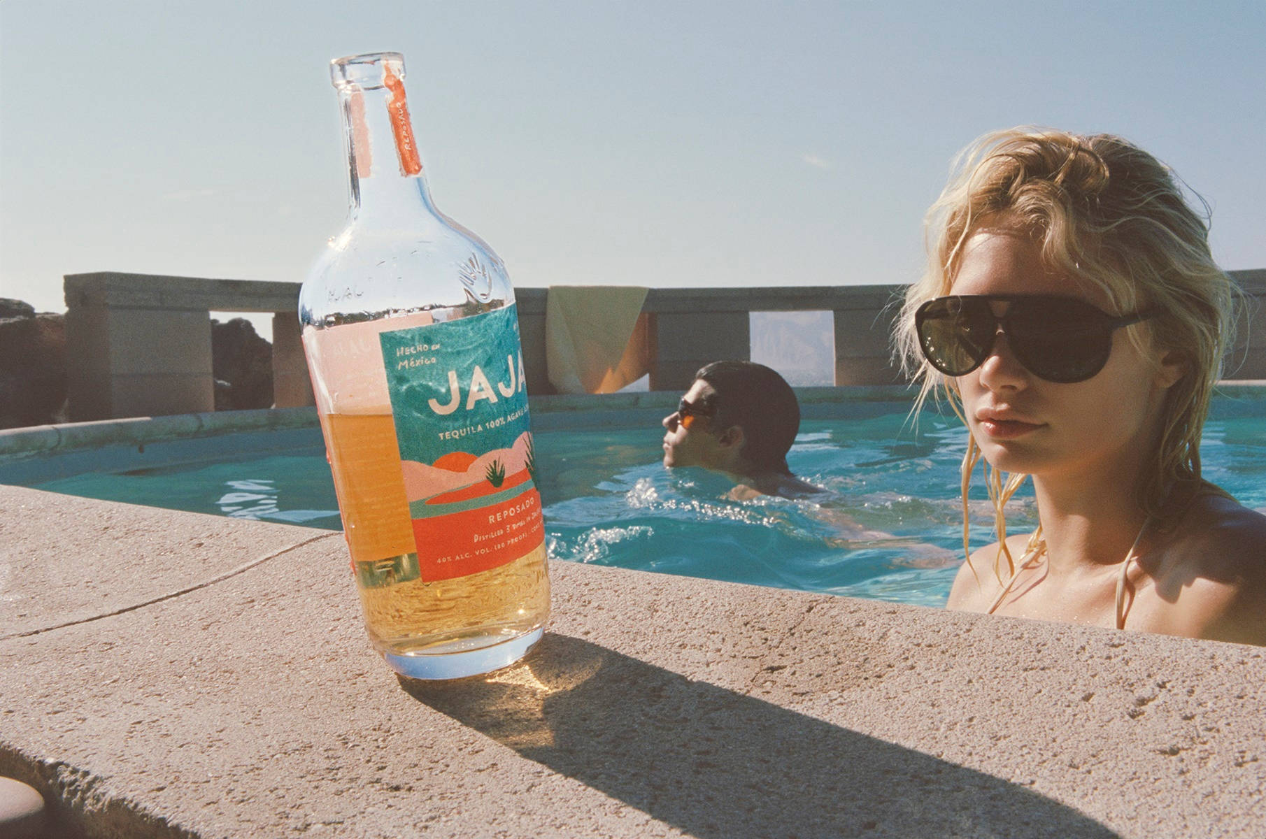 Jaja Tequilla Bottle At Pool Background