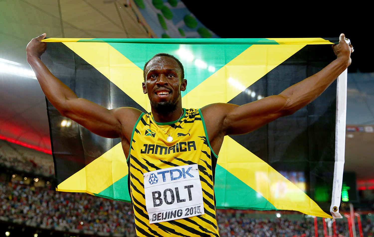Jamaican Athlete Holding National Flag