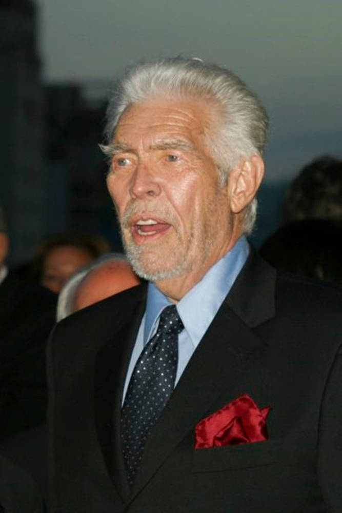 James Coburn In A Suit Background