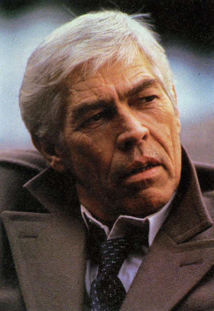 James Coburn In A Trench Coat Background