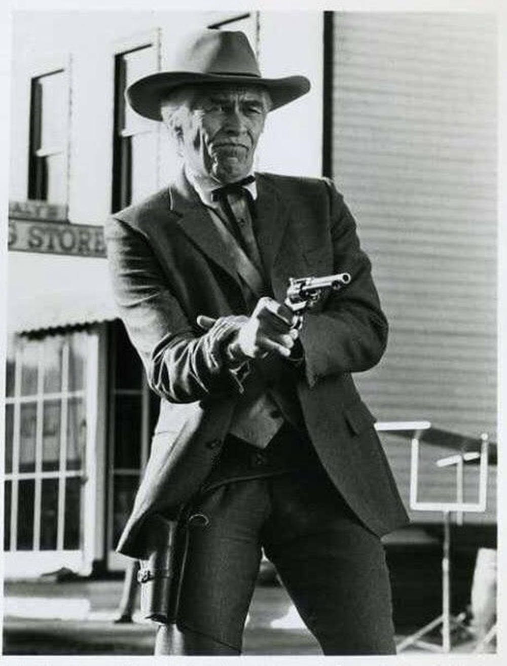 James Coburn With A Revolver Background