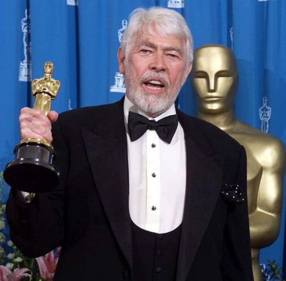 James Coburn With His Oscar Background