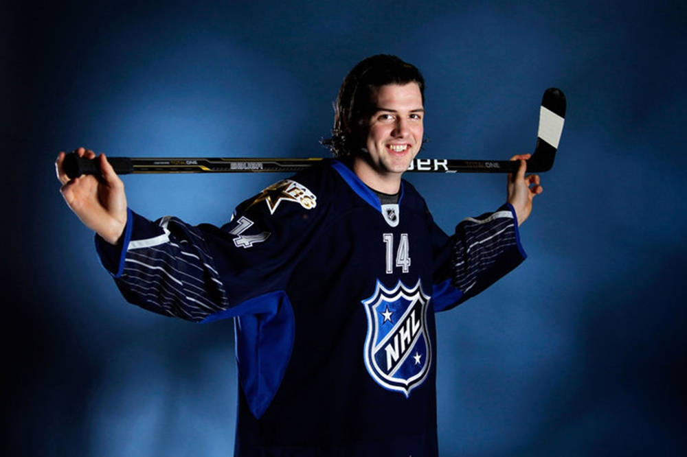 Jamie Benn Black And Blue Uniform Background