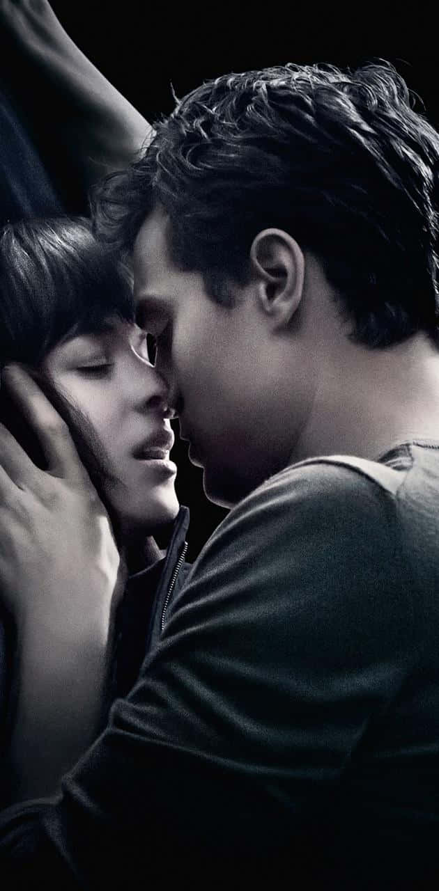 Jamie Dornan And Dakota Johnson As Christian Grey And Anastasia Steele In The Romantic-drama 50 Shades Of Grey Background