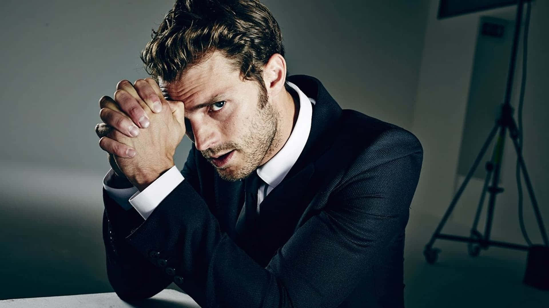 Jamie Dornan Posing In A Stylish Attire Background