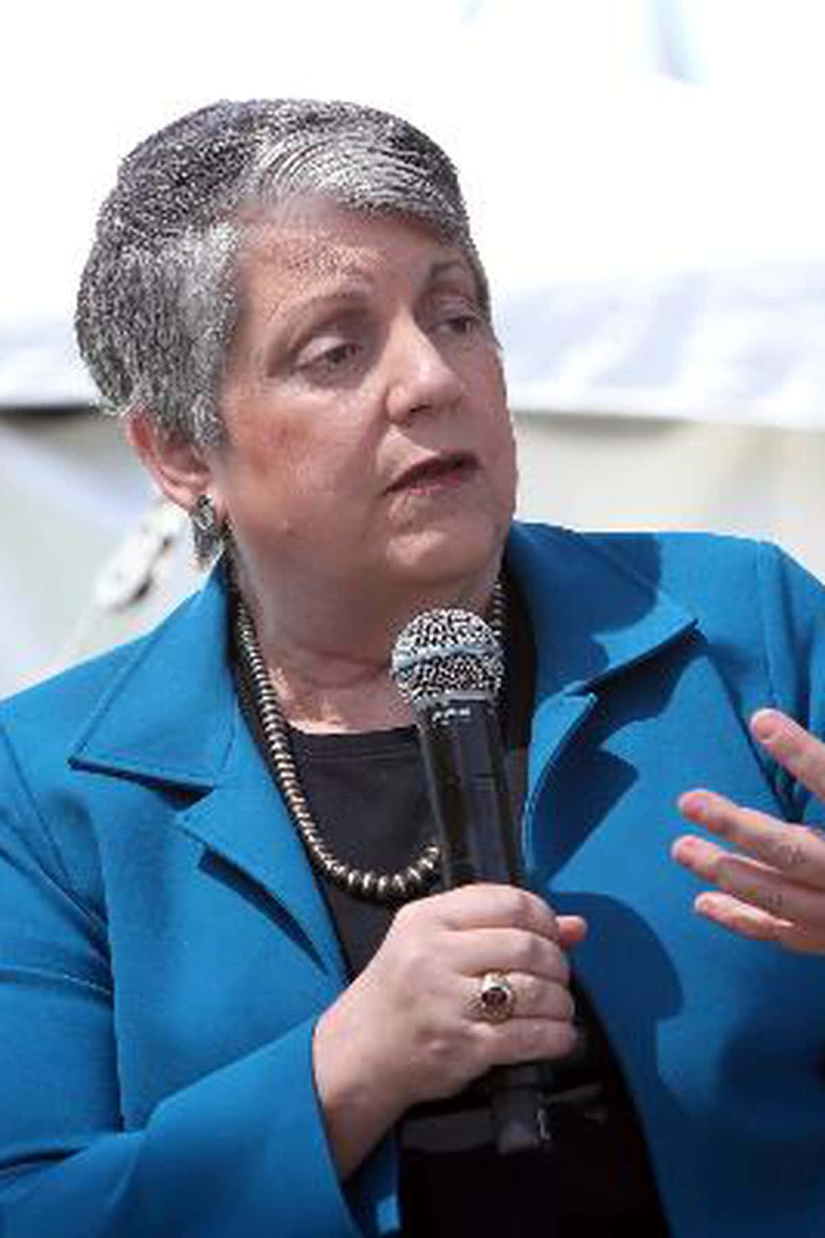 Janet Napolitano Holding Microphone Background