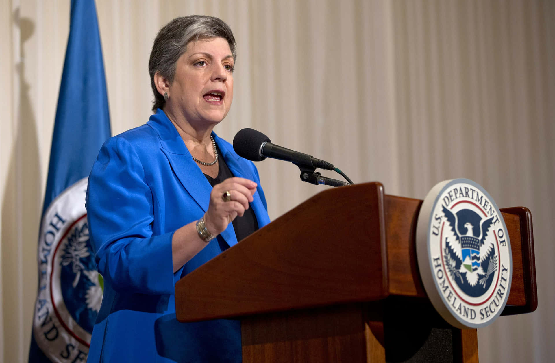 Janet Napolitano Speaking And Gesturing Background