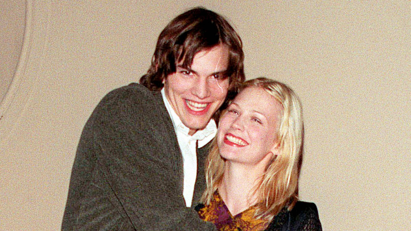 January Jones And Ashton Kutcher At A Celebrity Event Background