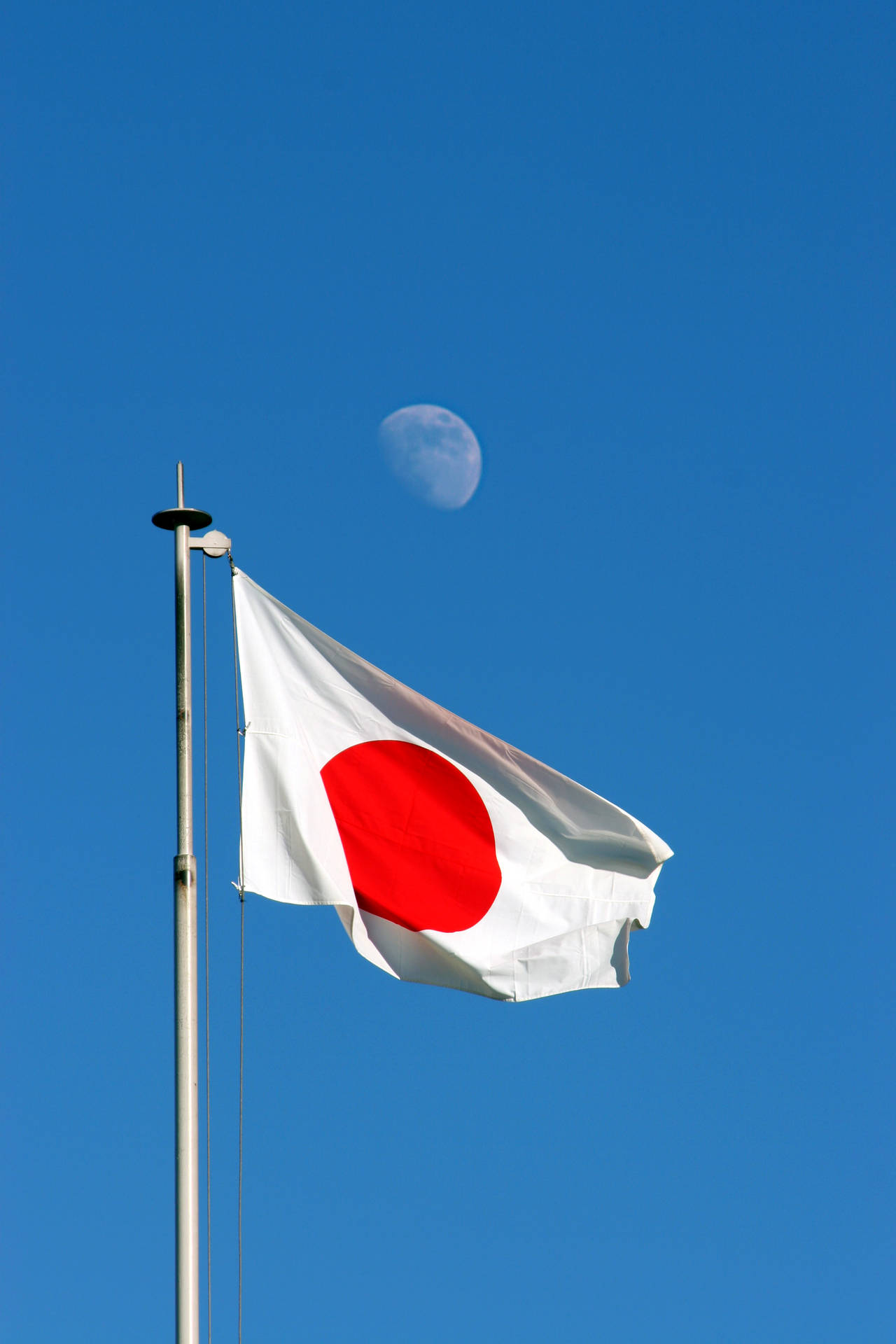 Japan Flag With Moon Behind Background