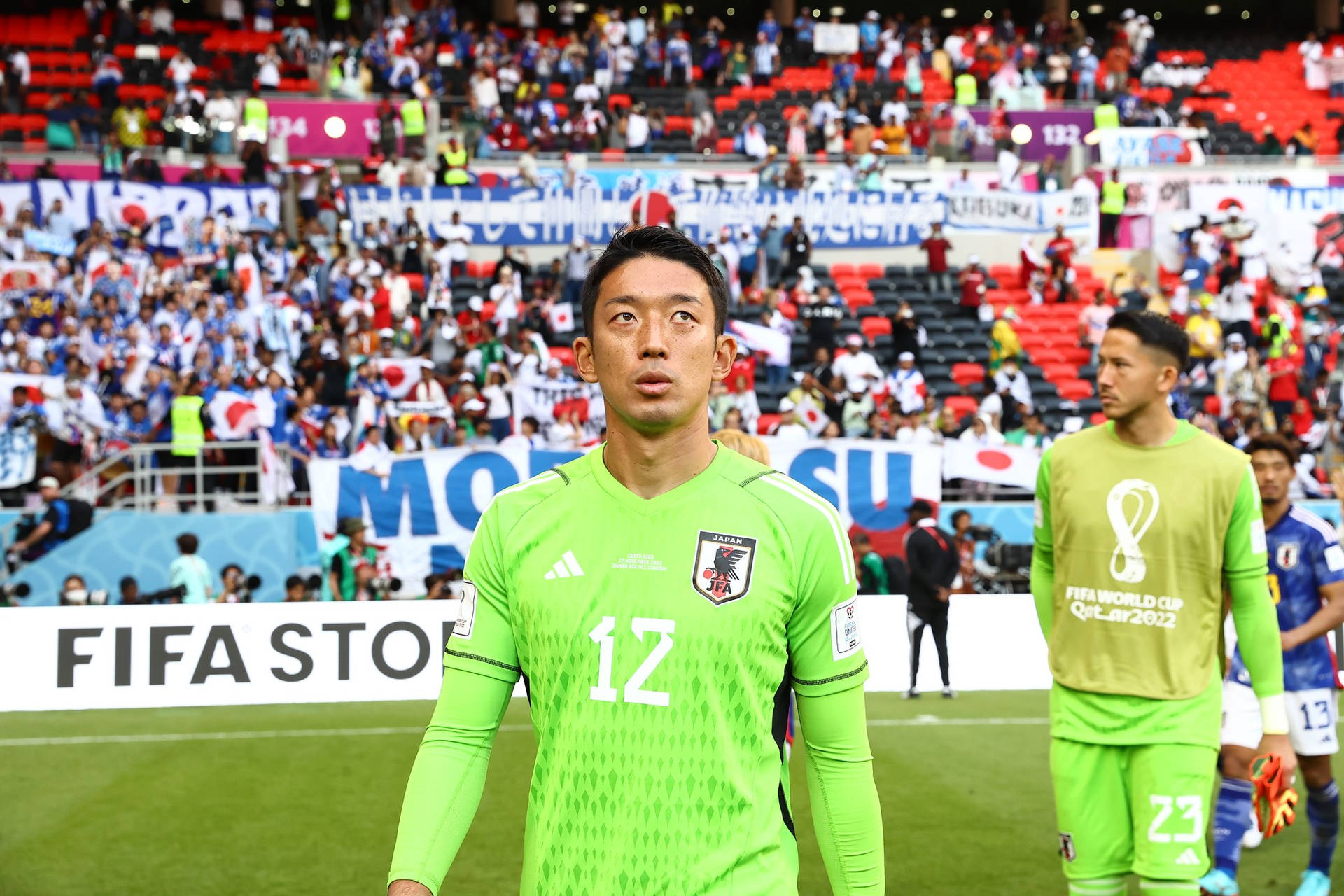 Japan National Football Team Looking Up Gonda Background