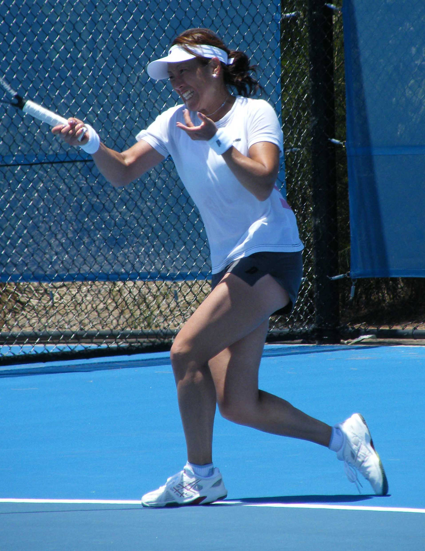 Japanese Tennis Legend Ai Sugiyama In Mid-game Action Background