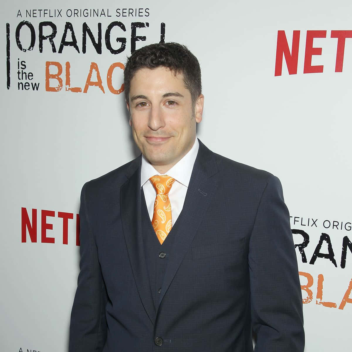 Jason Biggs Confidently Looking At The Camera Background