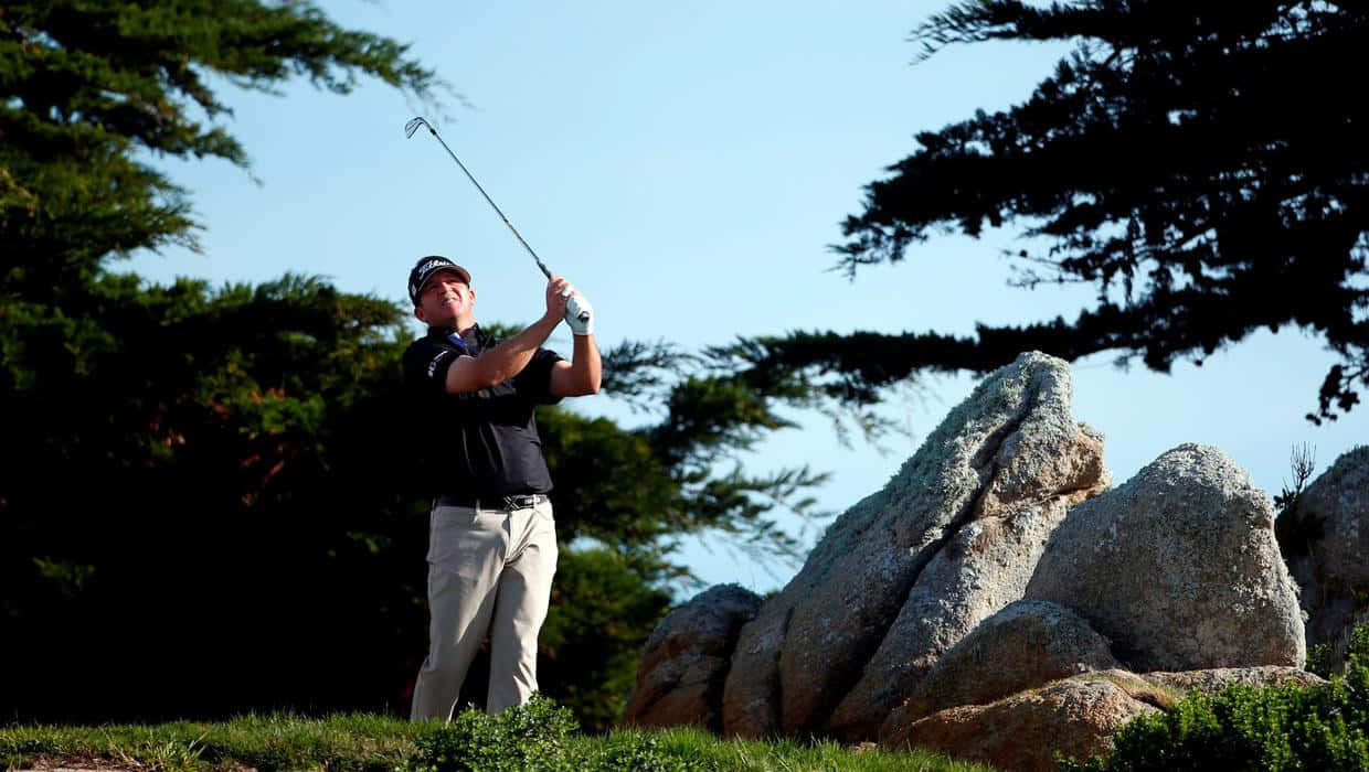 Jason Bohn Beside A Rock Background