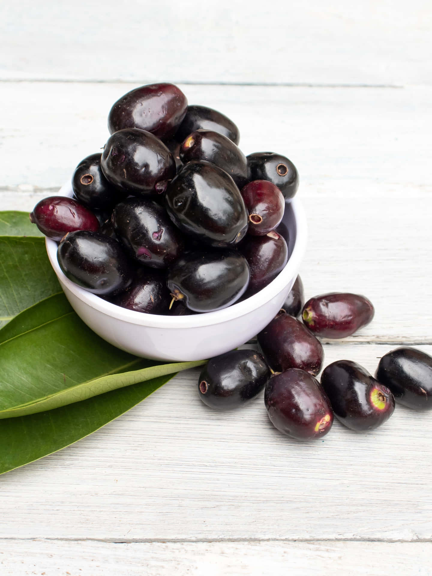 Java Plums In A White Bowl Background