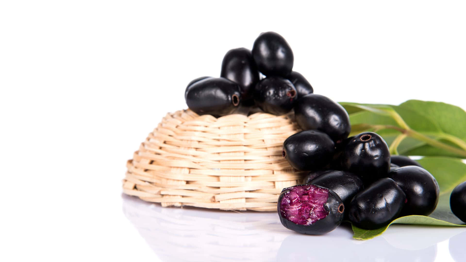 Java Plums On A Turned Over Wicker Basket Background