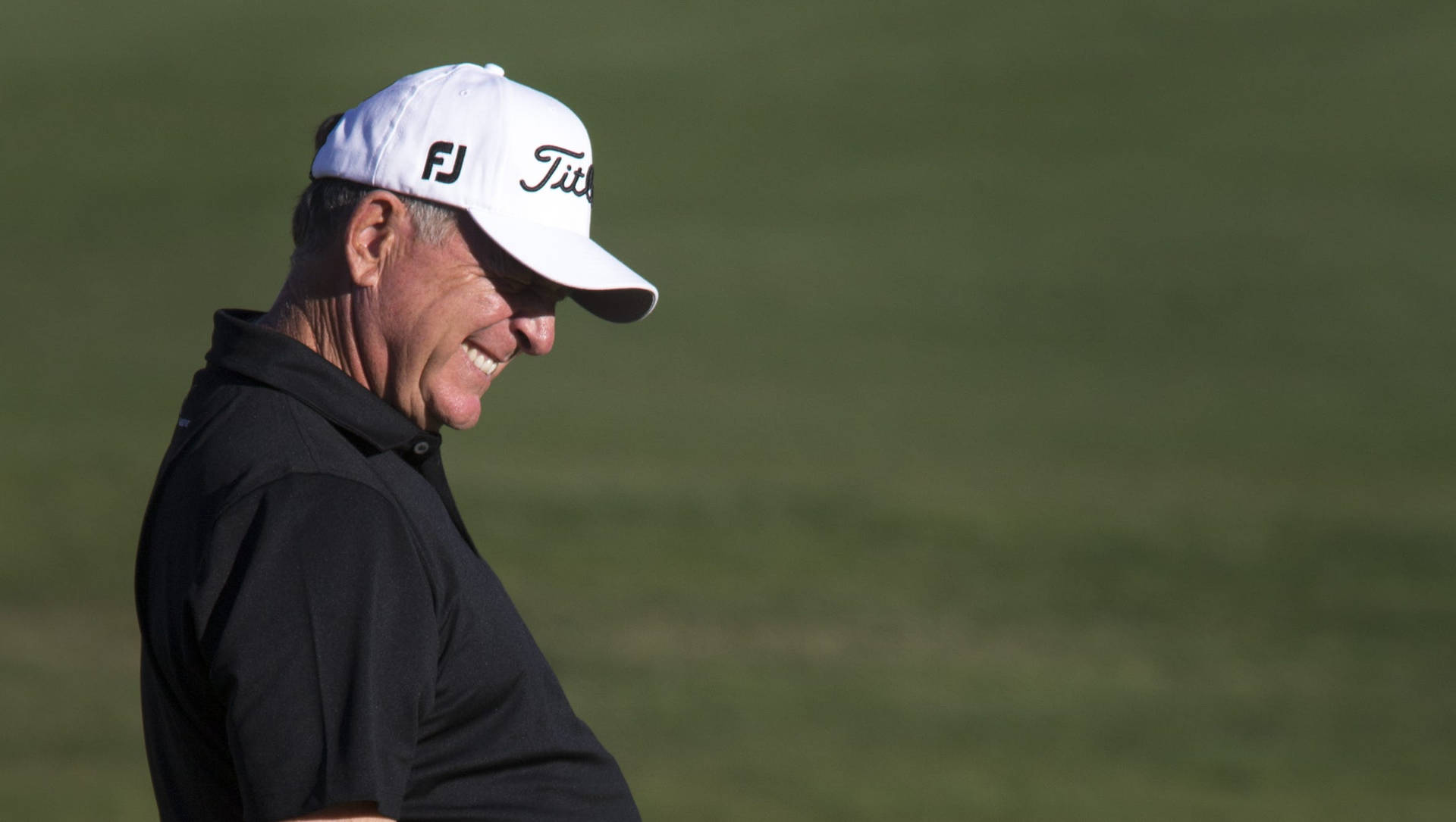 Jay Haas Smiling During A Golf Event Background