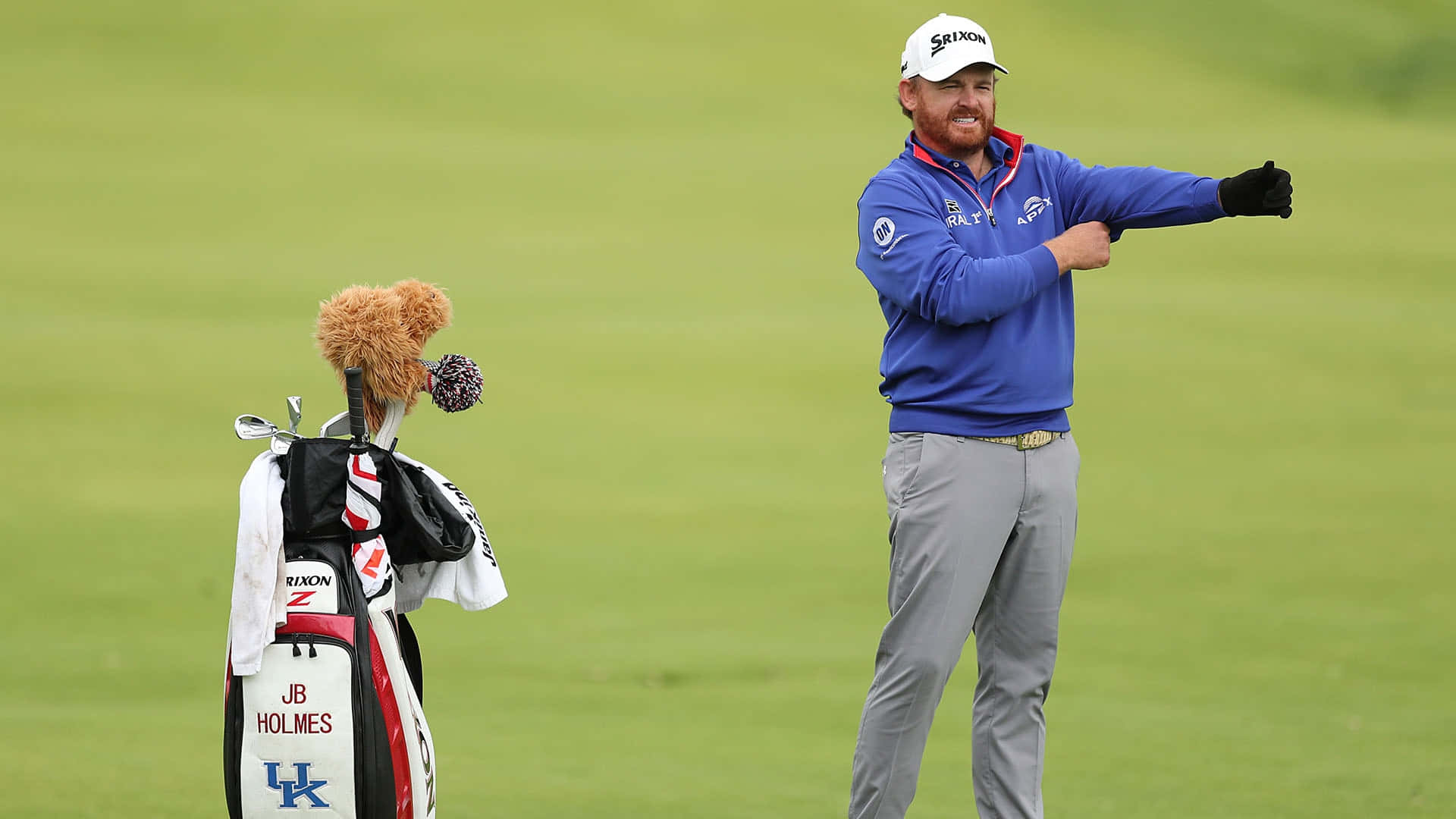 Jb Holmes With Golf Equipment Bag Background