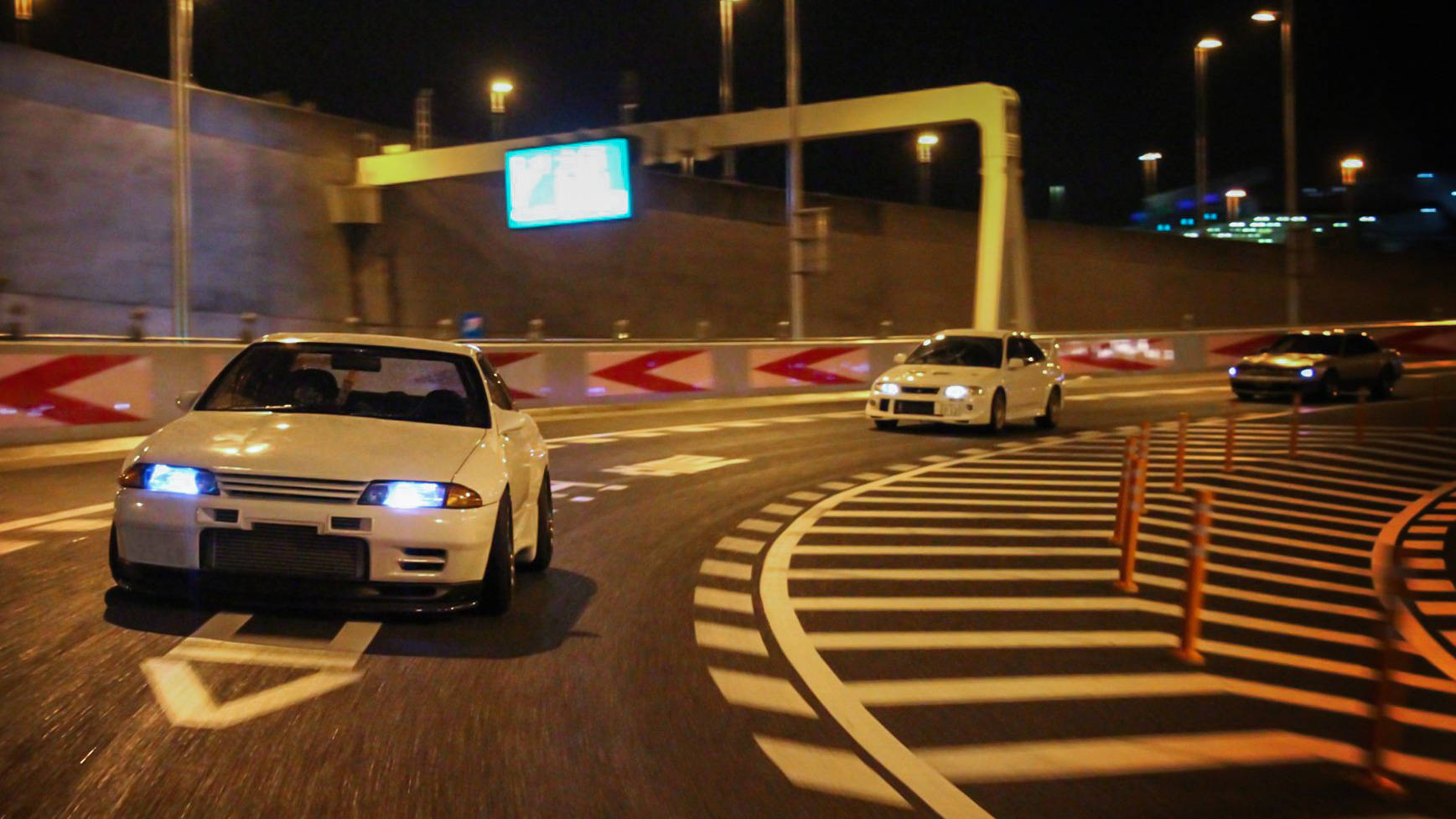 Jdm Cars Racing In Night City Background