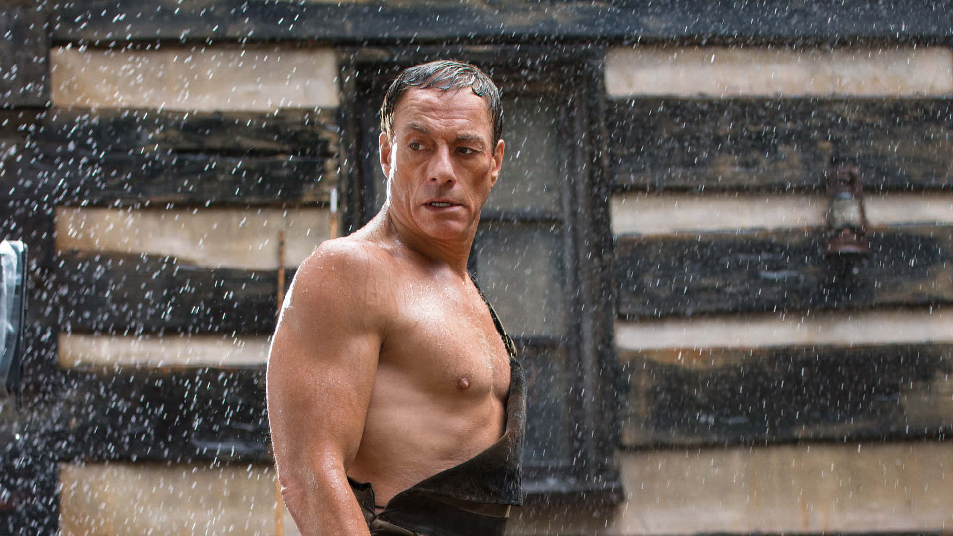 Jean Claude Van Damme Flexing His Muscled Stance Background
