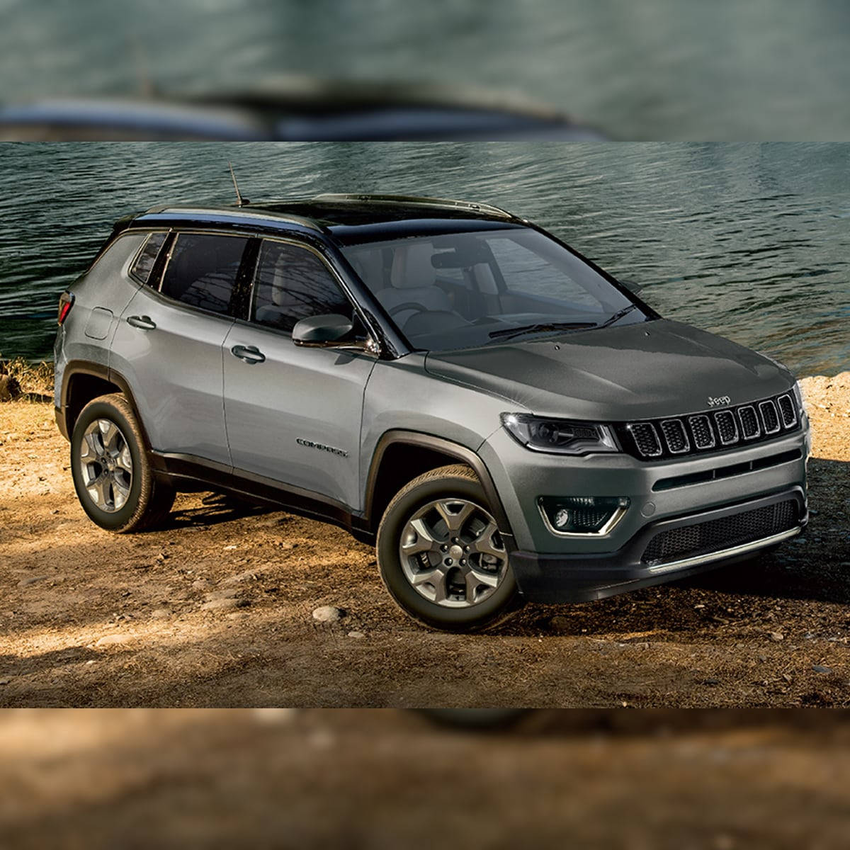 Jeep Compass On Dirt By Water Background