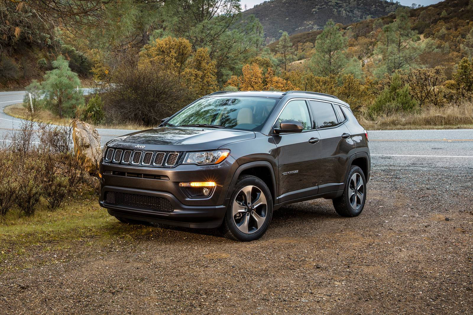 Jeep Compass On Dirt With Plants Background