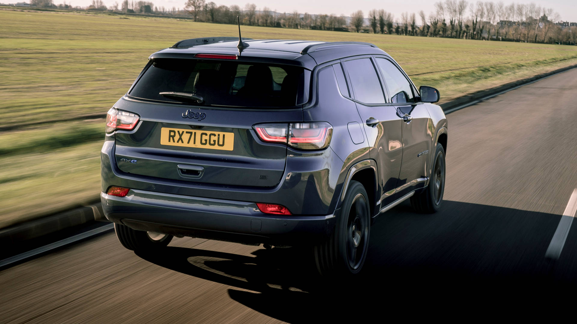 Jeep Compass On Road With Grass Background