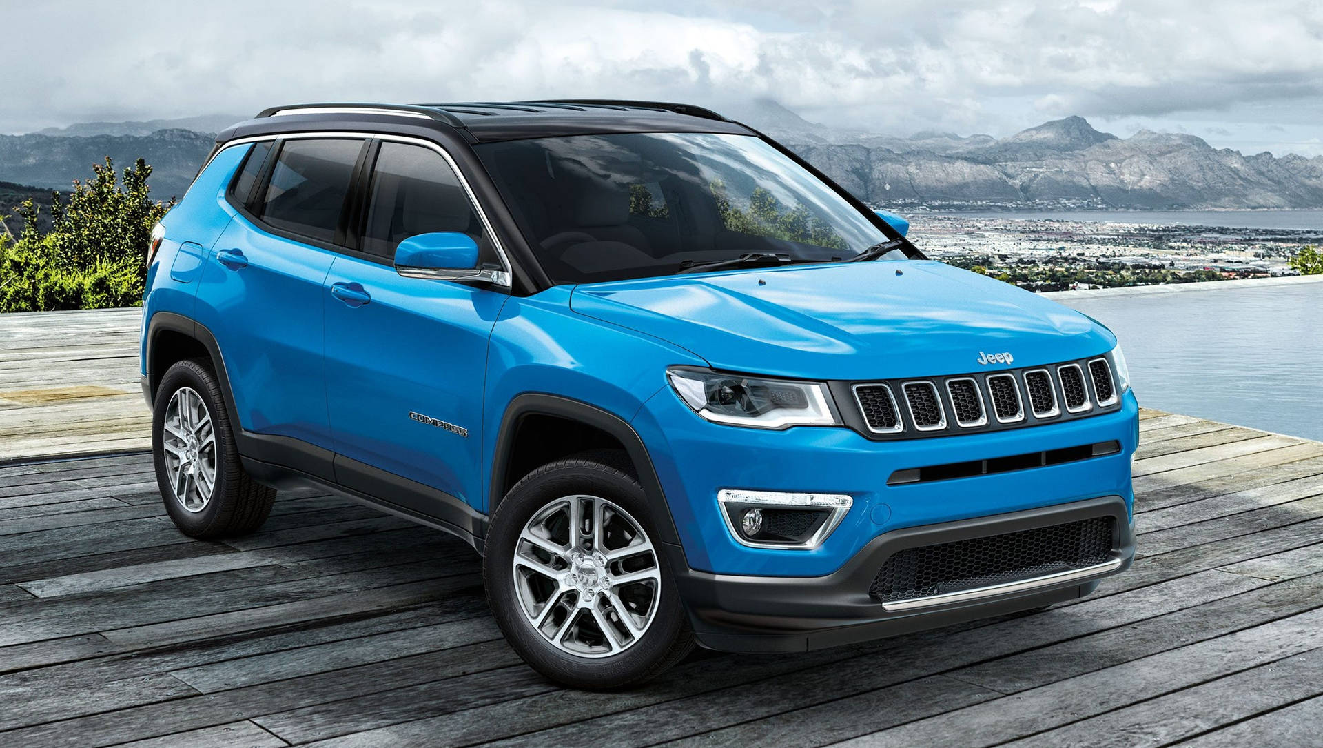 Jeep Compass On Wooden Floor By Water Background